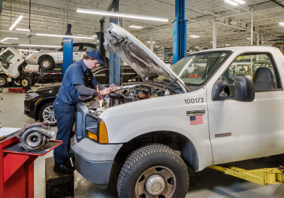 A diesel repair specialist working on a diesel truck in a garage